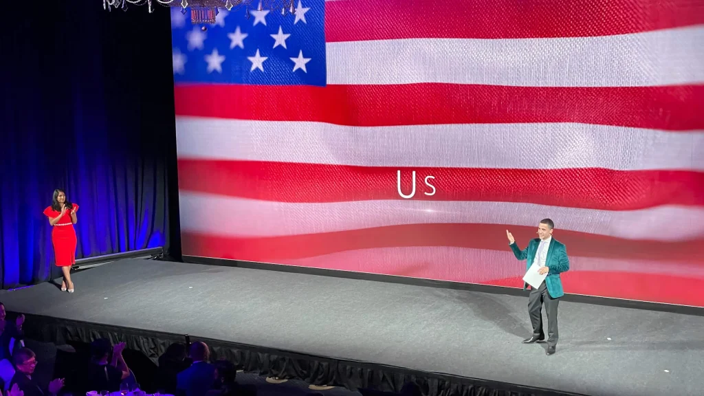 US flag backdrop on stage